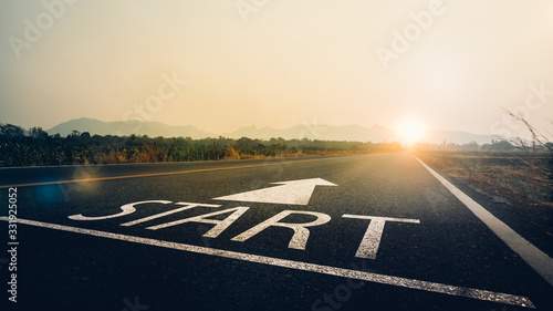 Concept of start straight and beginning for cooperation.Start text on the highway road concept for planning and challenge or career path,business strategy,opportunity and change in sunset background.