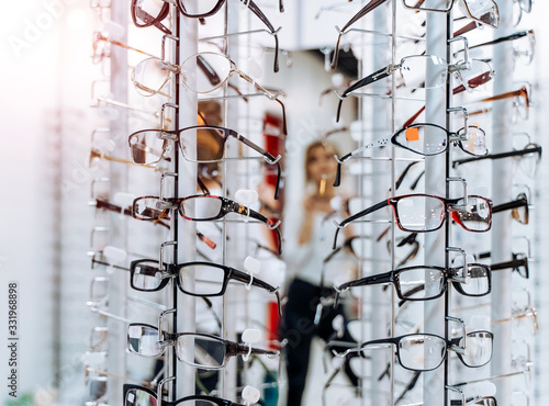 Sales rack of glasses. Display of glasses for sale. Closeup. Stand with glasses in the store of optics.