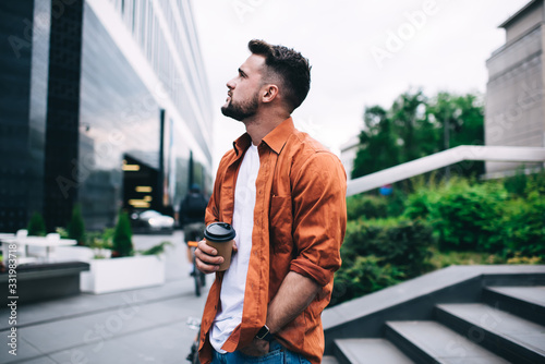 Peaceful guy with coffee chilling outside