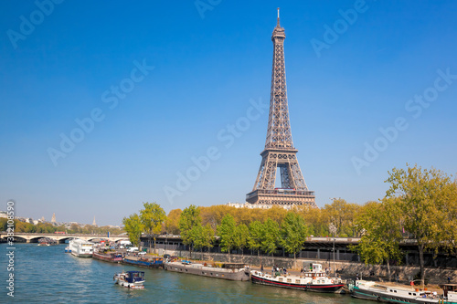 Paris with Eiffel Tower against boats during spring time in France