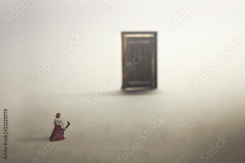 small woman carries the key to open the door, concept of freedom