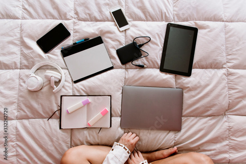 girl with freelance devices on bed with white padded