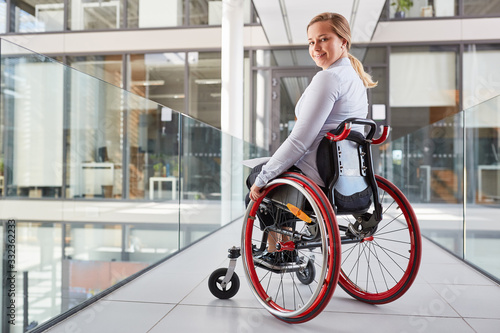 Smiling young woman in a wheelchair for inclusion