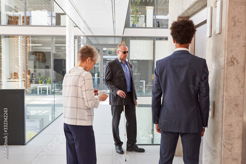 Business people and a blind man with a cane