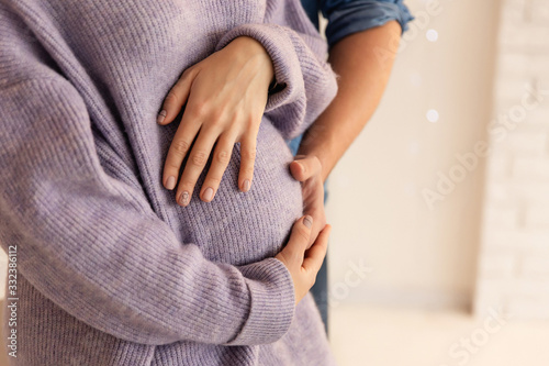 Beautiful pregnancy of young family. Pregnant woman and man. Happy couple, wife and husband hugging tummy