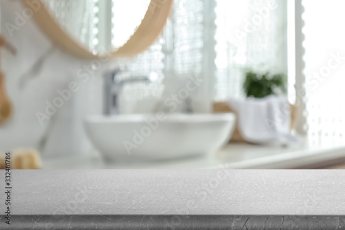 Empty table and blurred view of stylish bathroom interior