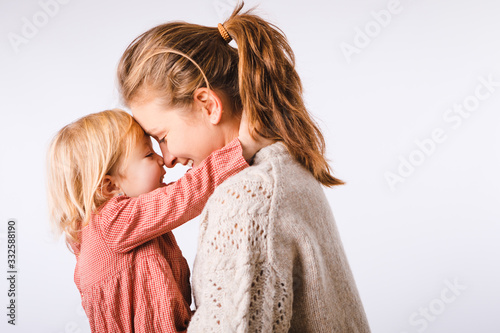 Mama and her little daughter on a white background. Mothers Day.