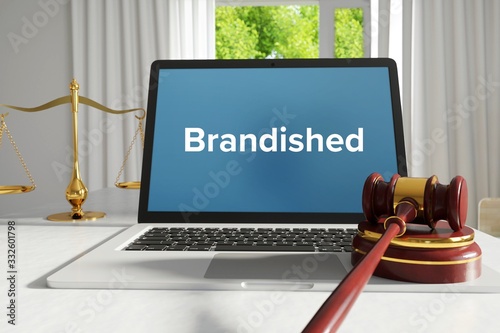 Brandished – Law, Judgment, Web. Laptop in the office with term on the screen. Hammer, Libra, Lawyer.