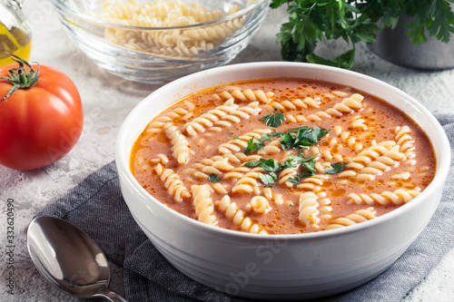 Tomato soup with fusilli pasta in the bowl