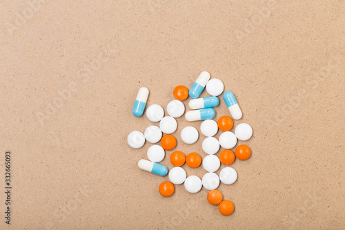 Treatment. Pharmaceutical medicine pills, tablets and capsules on beige background. Free space. Healthcare concept. 
