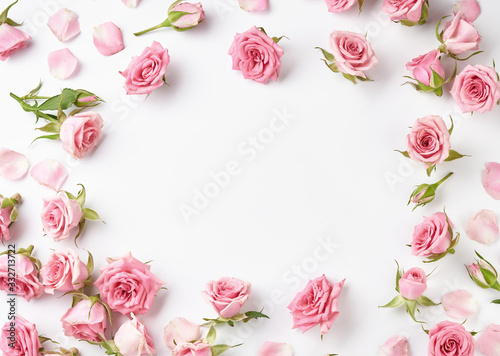 Rose flowers on white background with copy space for design, text. Top view of pink roses and rose buds.