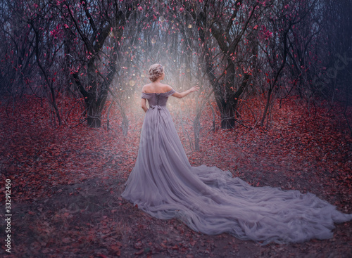 art photo young beauty woman queen. autumn purple mystic tree. fantasy entrance world magic divine glowing in dark deep forest. lady princess in elegant vintage dress, long train back medieval clothes