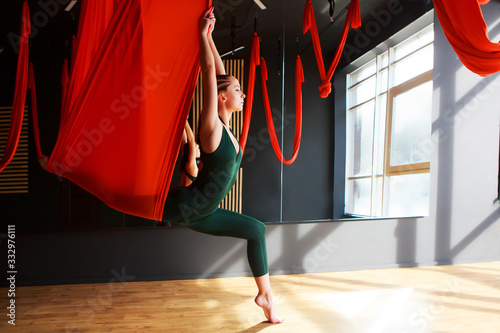 yoga instructor practicing fly yoga in the gym.