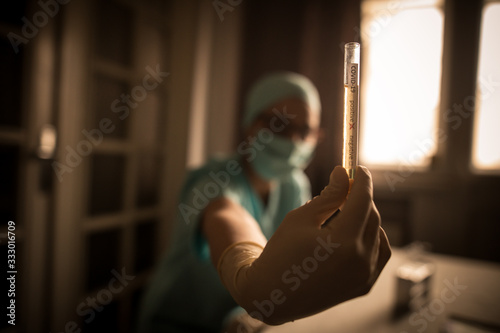 Doctor hands holding a coronavirus COVID-19 positive test tube