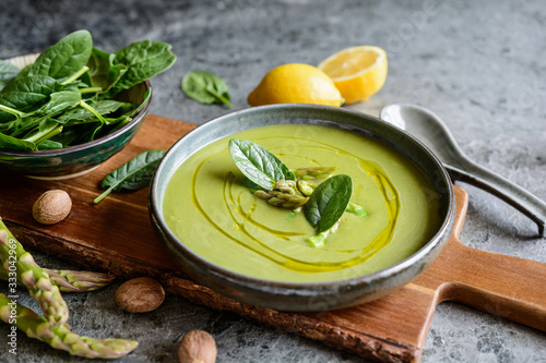 Creamy asparagus and spinach soup in a ceramic plate