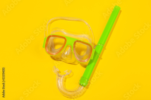 Diving mask on yellow background. Concept of beach holiday, sea tour, warm sunny summer. Advertising space