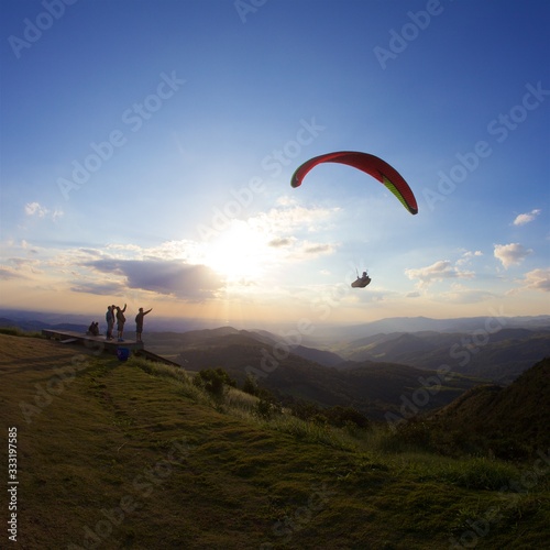Paragliding over Brazilian mountains at sunset