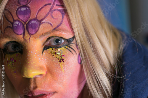 Attractive girl with a painted face. Aquagrum on the face of a woman.