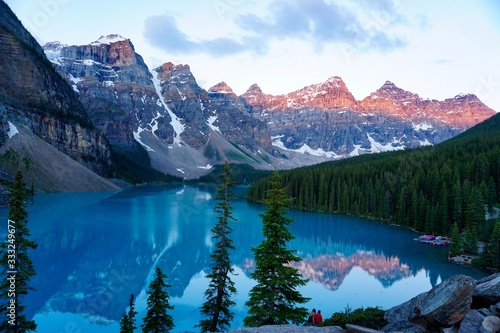 Early Morning Light Shines on the Mountains of the Canadian Rockies Overlooking a Serene Turquoise Lake, Alberta, CA