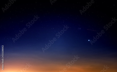 blue starry sky landscape at dusk against red sunset clouds background wide view of universe with stars Constellation in deep space Bright planet at twilight Astronomy nature wallpaper