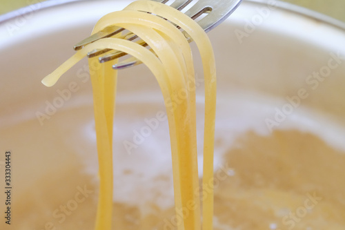 Spaghetti in pan cooking in boiling water, cooking pasta