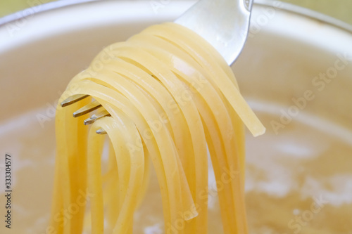 Spaghetti in pan cooking in boiling water, cooking pasta