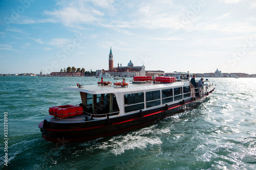 Small tourist ship in the sea near Venice. Transportation of tourists on a warm sunny day. Italy