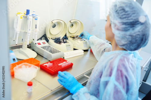 a female scientist makes PCR DNA tests in a modern chemical and bacteriological laboratory.