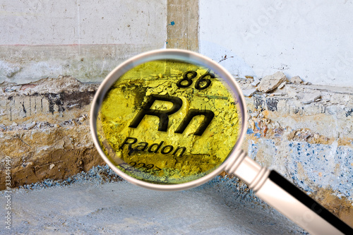 Preparatory stage for the construction of a ventilated crawl space in an old brick building - Searching gas radon concept image seen through a magnifying glass