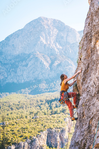 Girl climbs a rock.