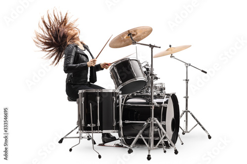 Female drummer playing the drums and throwing hair back