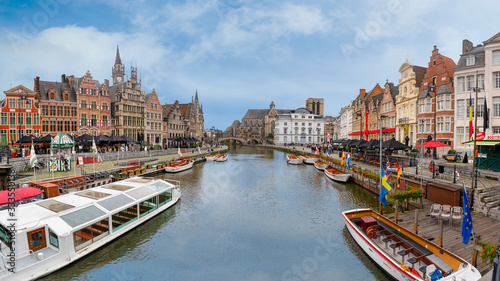 Ghent/Belgium - October 10, 2019: Cityscape with view of Sint-Michielsbrug, Stone arch bridge in the city center and architecture traditional houses along Lys (Leie) river in Gent..