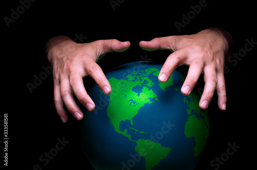 A pair of hands around an illustrated planet earth to depict a world domination and crisis concept.