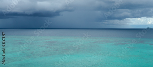 Tropical angry dark blue rain storm is approaching quickly over Indian ocean near Banyak islands, Sumatra. Perfect but still undiscovered holiday destination