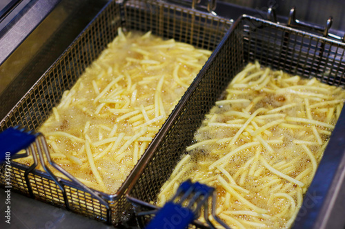 potato french fries cooking in a deep fryer