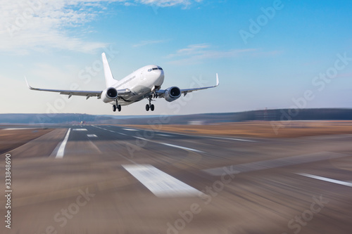 Runway at the airport and the plane flies and landing.