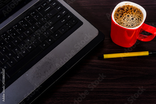 Work for home, computer, solve coffee Red paka yellow on a wooden floor New technology