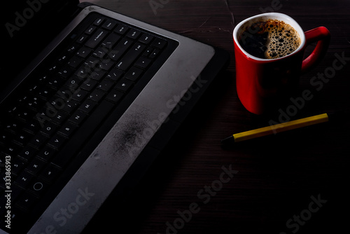 Work for home, computer, solve coffee Red paka yellow on a wooden floor New technology