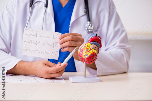 Young male doctor cardiologist working in the clinic