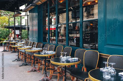 Tables and chairs in outdoor cafe in Paris, France.