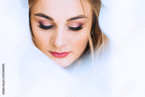 tulle around the bride's face. bride with beautiful makeup close