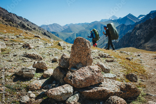 Beautiful Mountain landscape with tourist. Hiking on Lovely scenery with blue sky, high rocks, stones Trekking mountains.