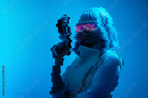 Girl with blaster in the futuristic battle. Concept virtual reality, cyber game. Image with glitch effect.