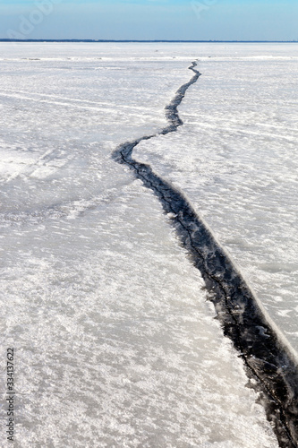 Ice crack on the baltic sea. Concept of collapsing relationships between people