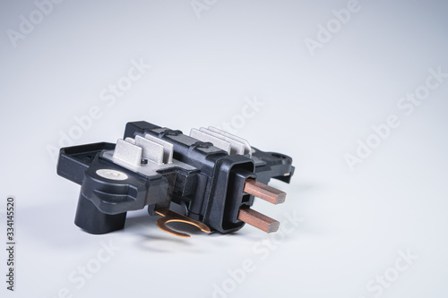 Automotive relay voltage regulator voltage regulator. New electric car spare parts on gray background