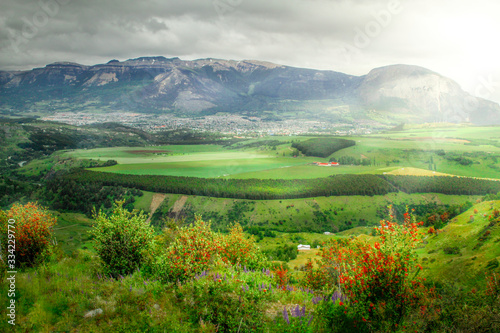 panoramic of the city and the countryside in coyhaique chilean patagonia with sun rays and green vegetation