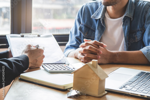 relocation / buy new house business concept. property agent / landlord explaining rental document condition to client / tenant before sign rental contract agreement .