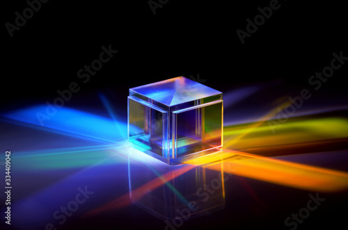 a crystal cube reflects colored rays