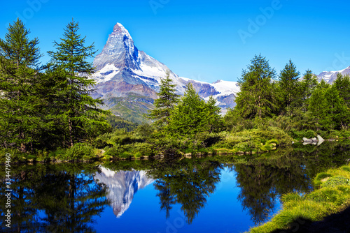 picturesque beautiful landscape with lake and fir trees on background Matterhorn in the Swiss Alps, near Zermatt, Switzerland. Amazing places. (Meditation, antistress - concept).