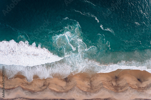 View from a drone to a cape and Pacific coast at sunset